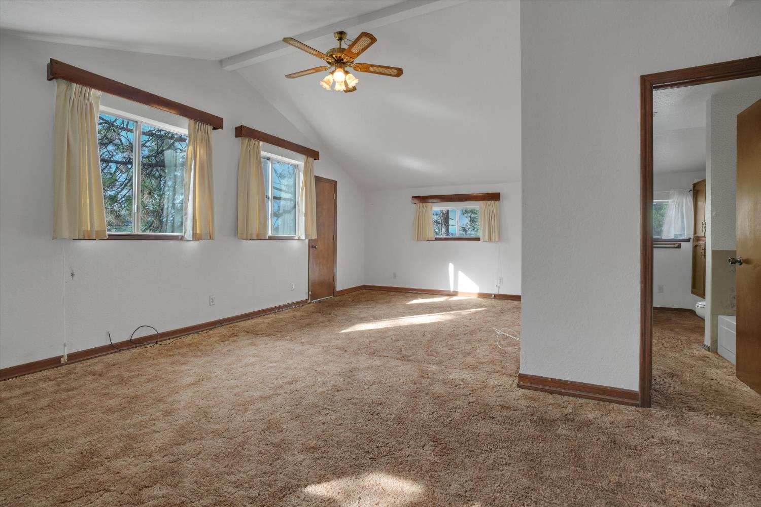 12066 Breckenridge Road Groveland, CA 95321 - Photo 23 of 41 an empty room with windows and ceiling fan