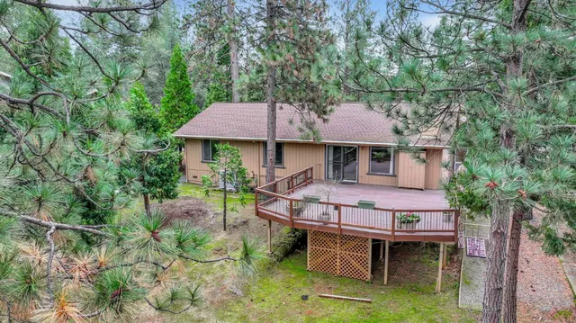 a patio with table and chairs under an umbrella