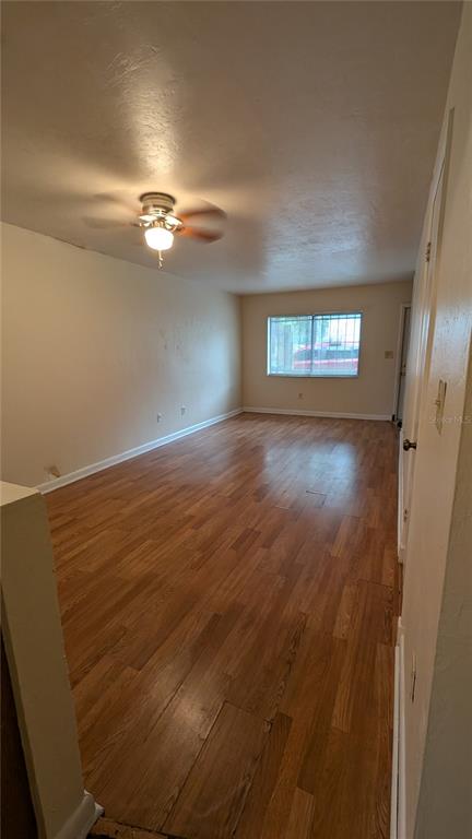625 Southwest 67th Terrace, Unit A B C D Gainesville, FL 32607 - Photo 2 of 8 wooden floor in an empty room with a window