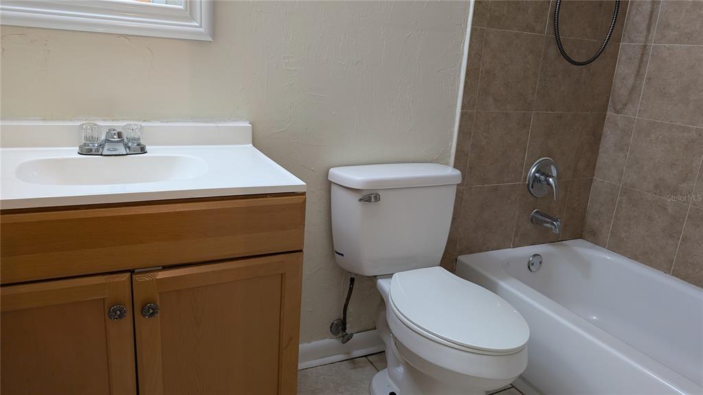 625 Southwest 67th Terrace, Unit A B C D Gainesville, FL 32607 - Photo 8 of 8 a bathroom with a sink a toilet and shower