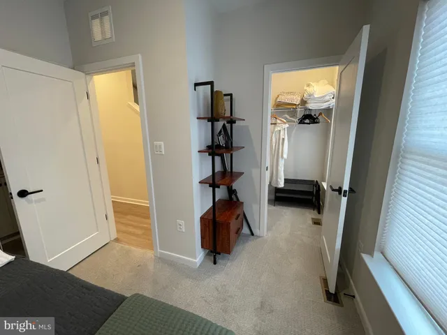 a roof deck with table and chairs and potted plants