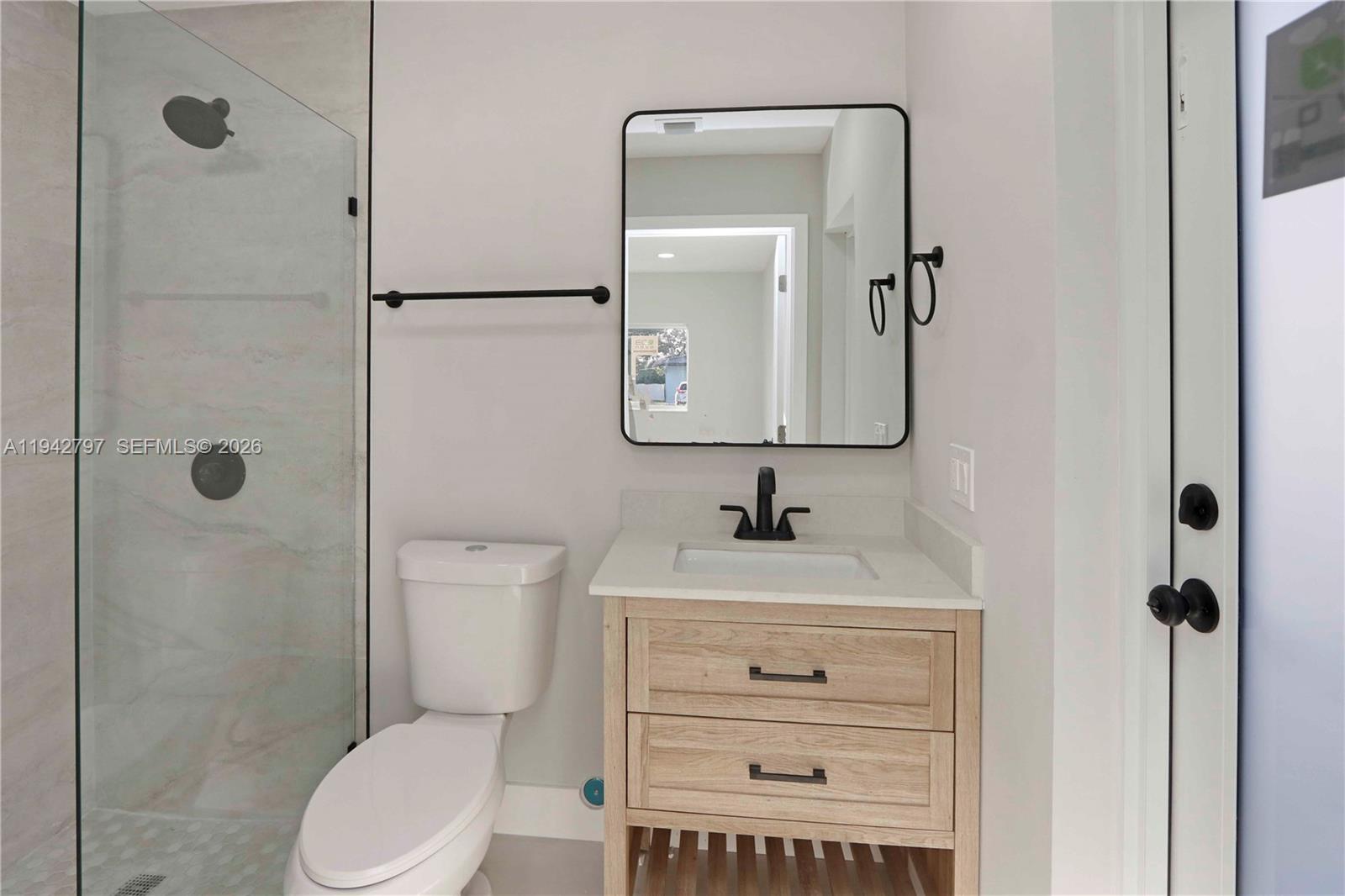 16232 Southwest 107th Court Miami, FL 33157 - Photo 14 of 32 a bathroom with a toilet sink vanity and mirror