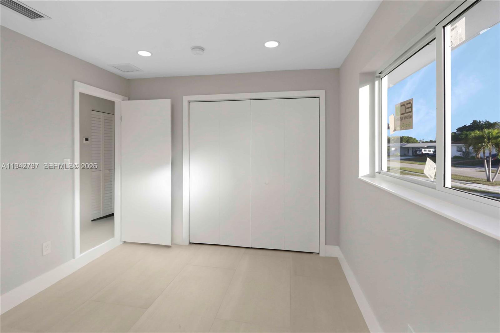 16232 Southwest 107th Court Miami, FL 33157 - Photo 19 of 32 an empty room with windows and closet