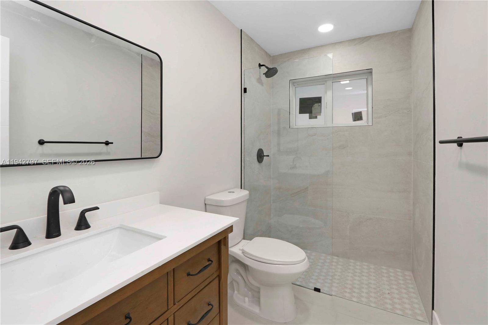 16232 Southwest 107th Court Miami, FL 33157 - Photo 20 of 32 a bathroom with a toilet sink and mirror