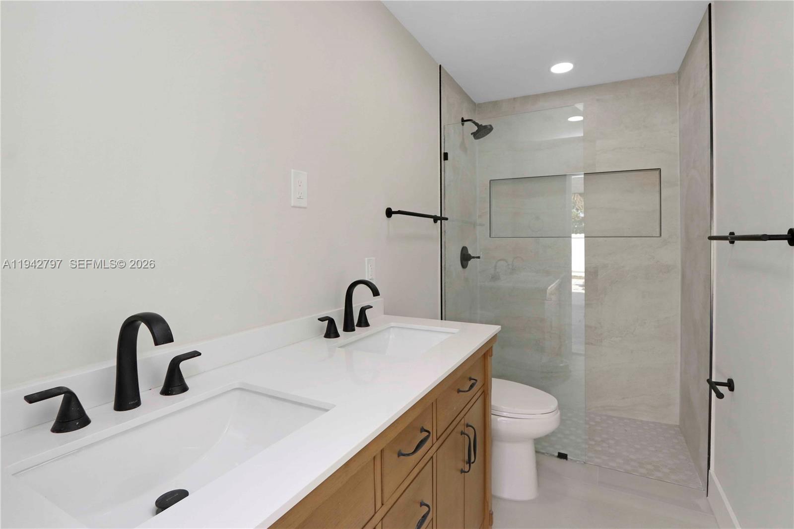 16232 Southwest 107th Court Miami, FL 33157 - Photo 23 of 32 a bathroom with a sink a toilet and a mirror