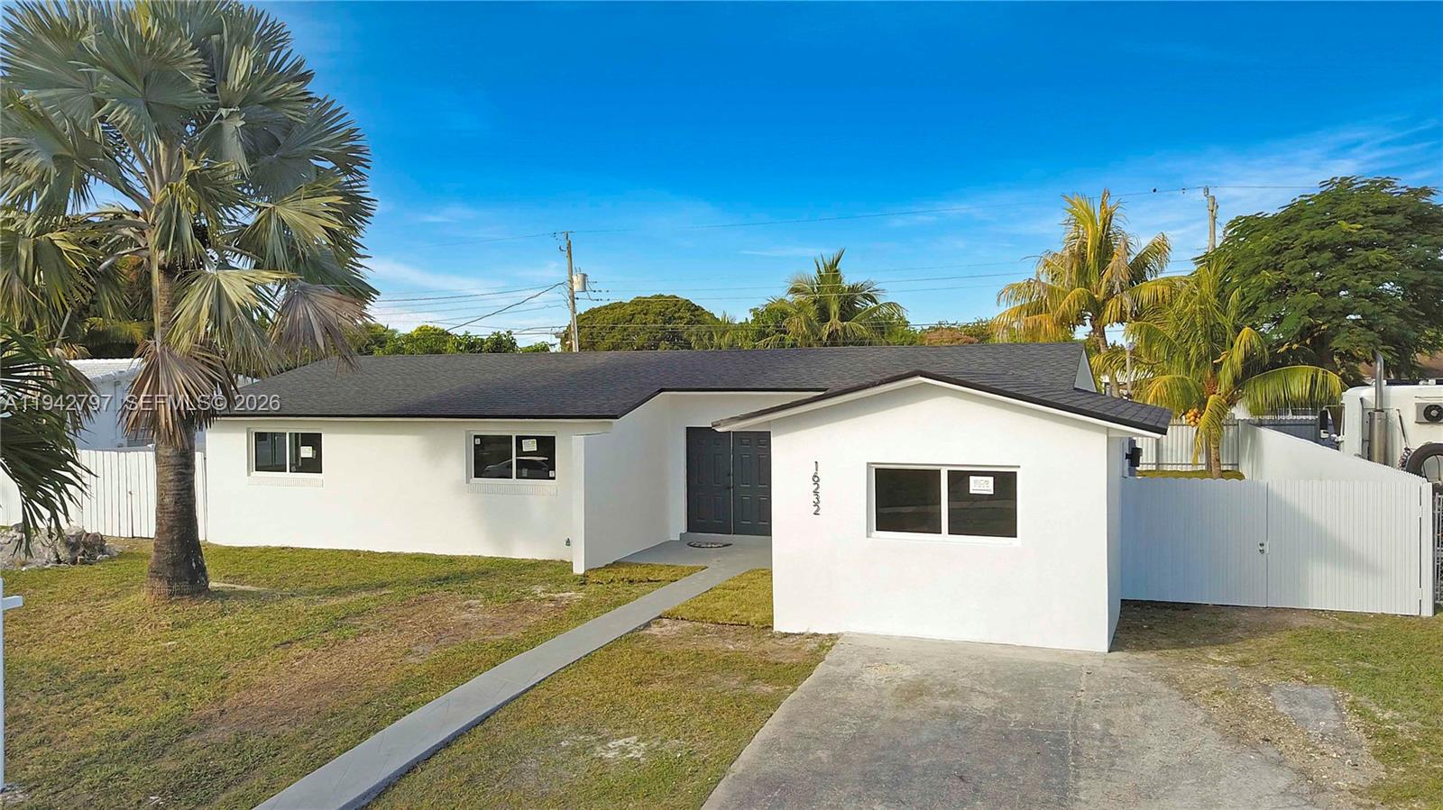 16232 Southwest 107th Court Miami, FL 33157 - Photo 30 of 32 a view of a yard in front of a house with a large tree