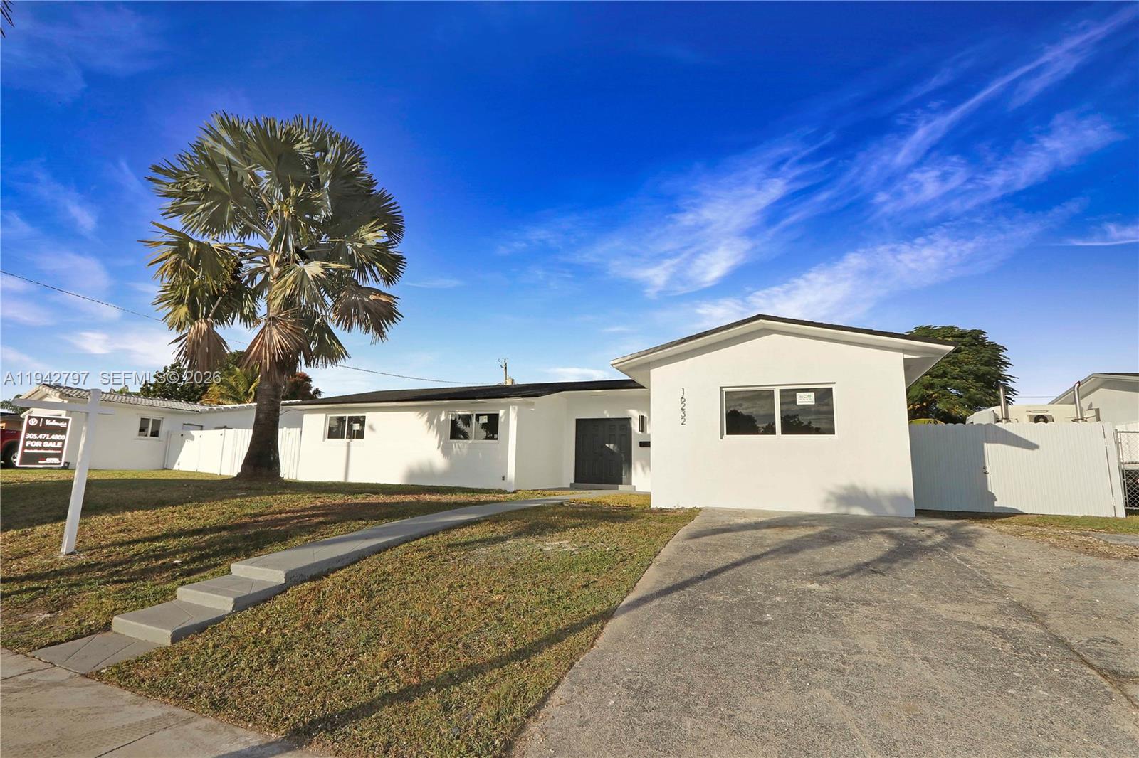 16232 Southwest 107th Court Miami, FL 33157 - Photo 31 of 32 a front view of a house with a yard