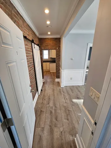 a view of entryway with stairs and wooden floor