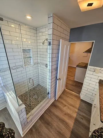 a bathroom with a toilet a sink and mirror