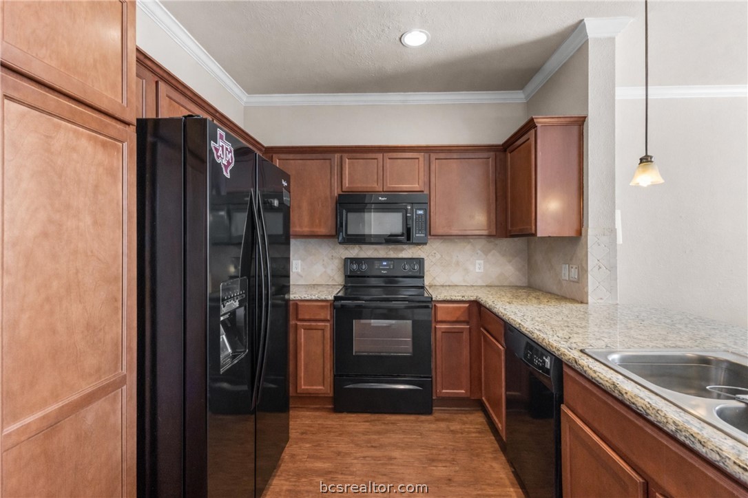 1198 Jones-Butler Road, Unit 3005 College Station, TX 77840 - Photo 7 of 24 a kitchen with stainless steel appliances granite countertop a refrigerator and a sink