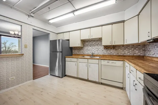 a kitchen with stainless steel appliances granite countertop a refrigerator sink and cabinets