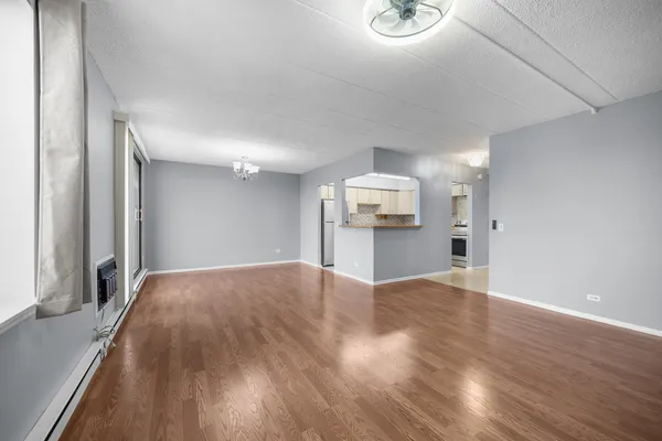 a view of a kitchen with wooden floor and electronic appliances