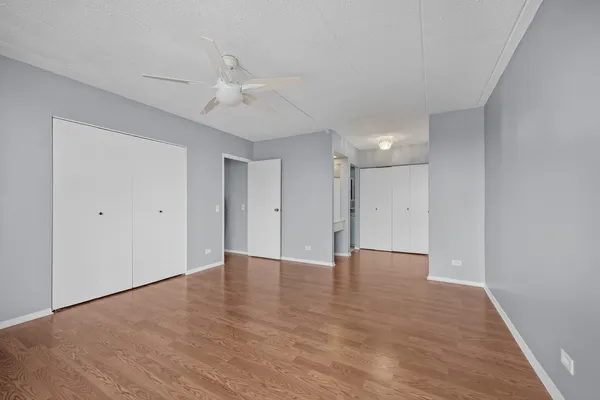 a view of an empty room with wooden floor