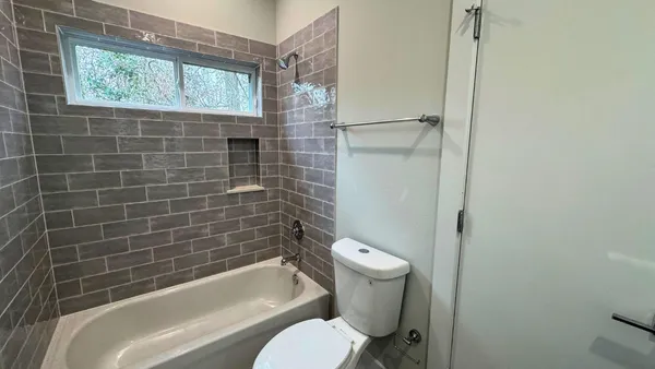 a bathroom with a toilet and bathtub