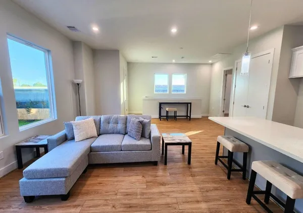 a living room with furniture and a pool table