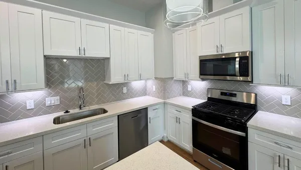 a kitchen with a sink and a stove top oven