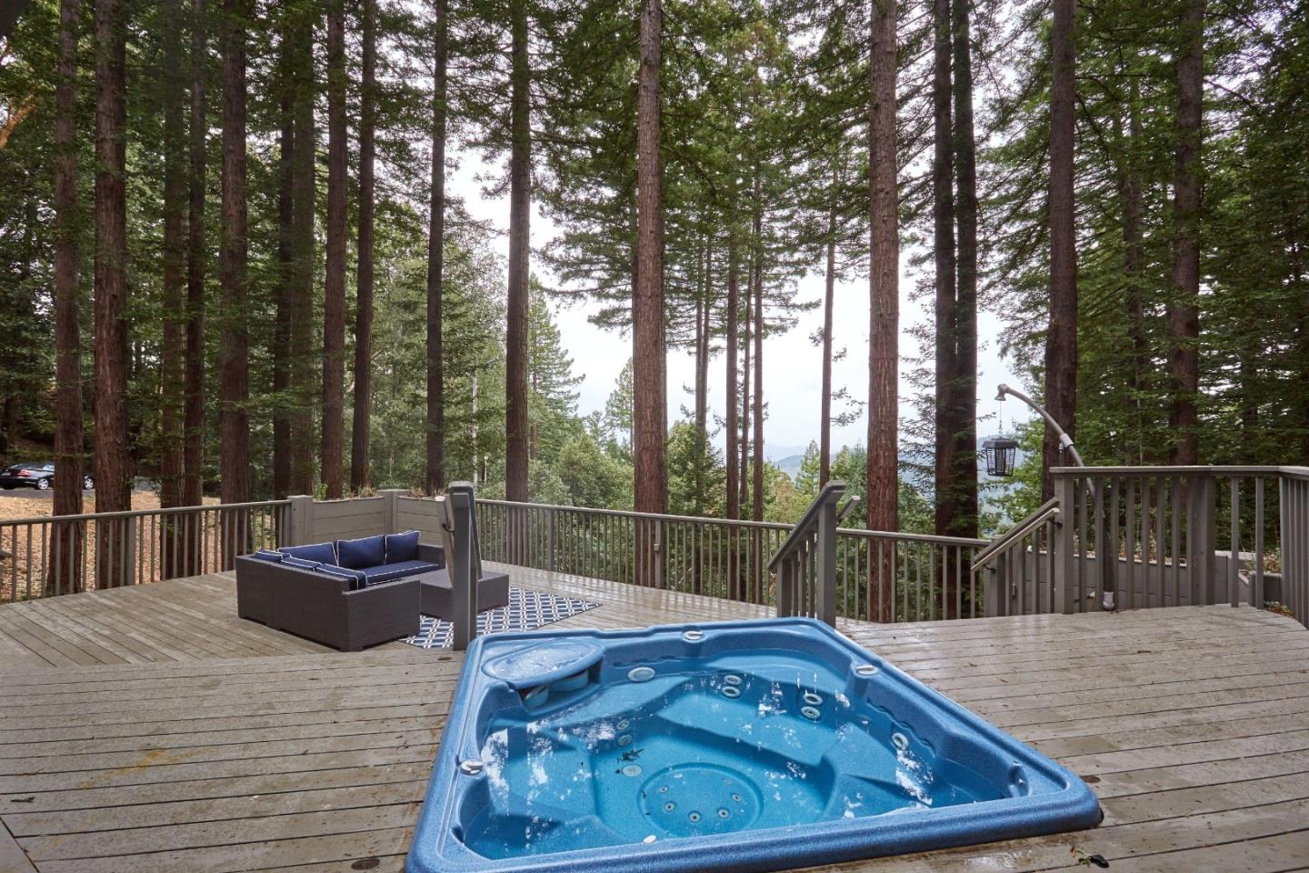 234 Swett Road Woodside, CA 94062 - Photo 19 of 20 a view of a roof deck with couches and wooden fence