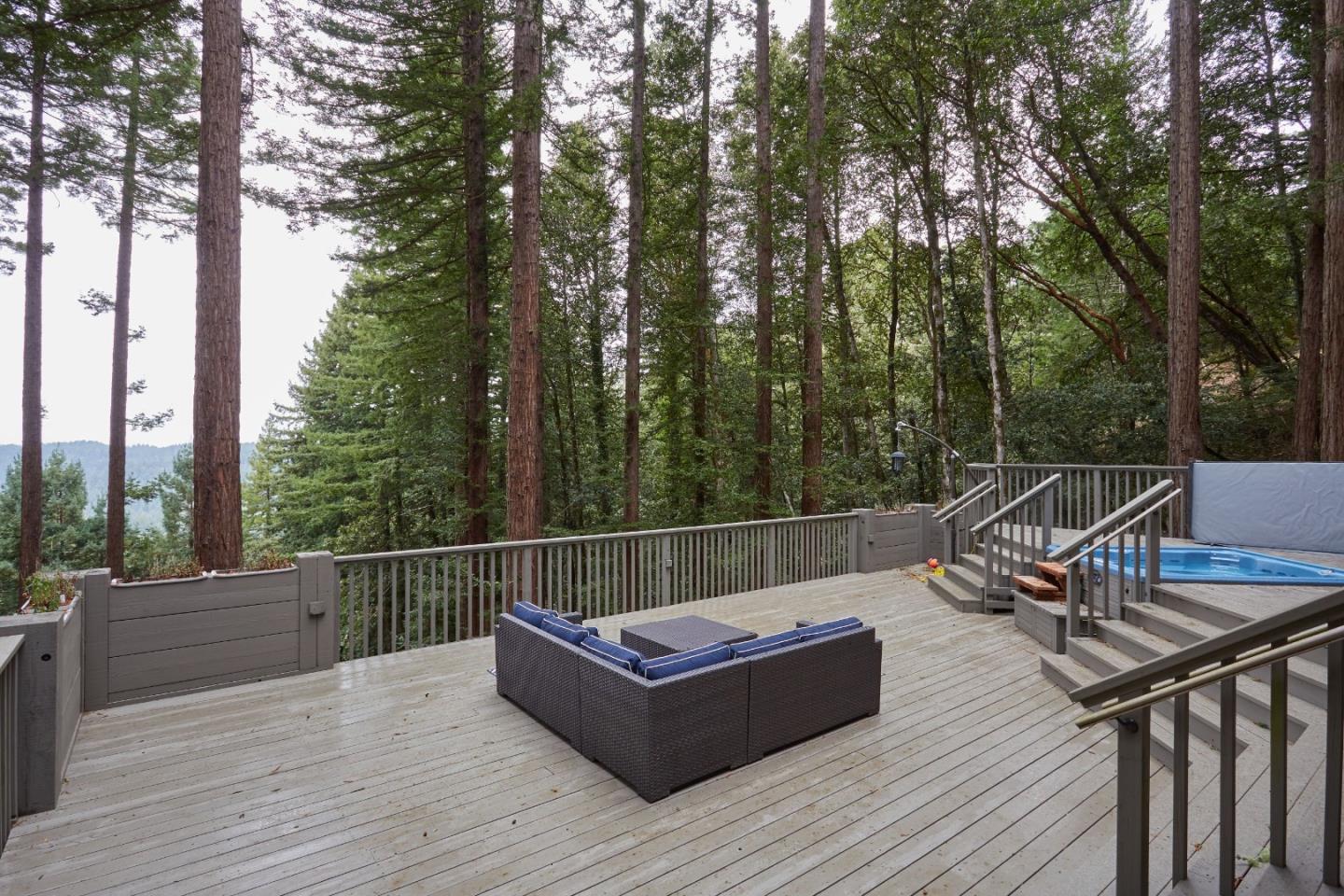 234 Swett Road Woodside, CA 94062 - Photo 20 of 20 a view of a roof deck with couches and wooden fence