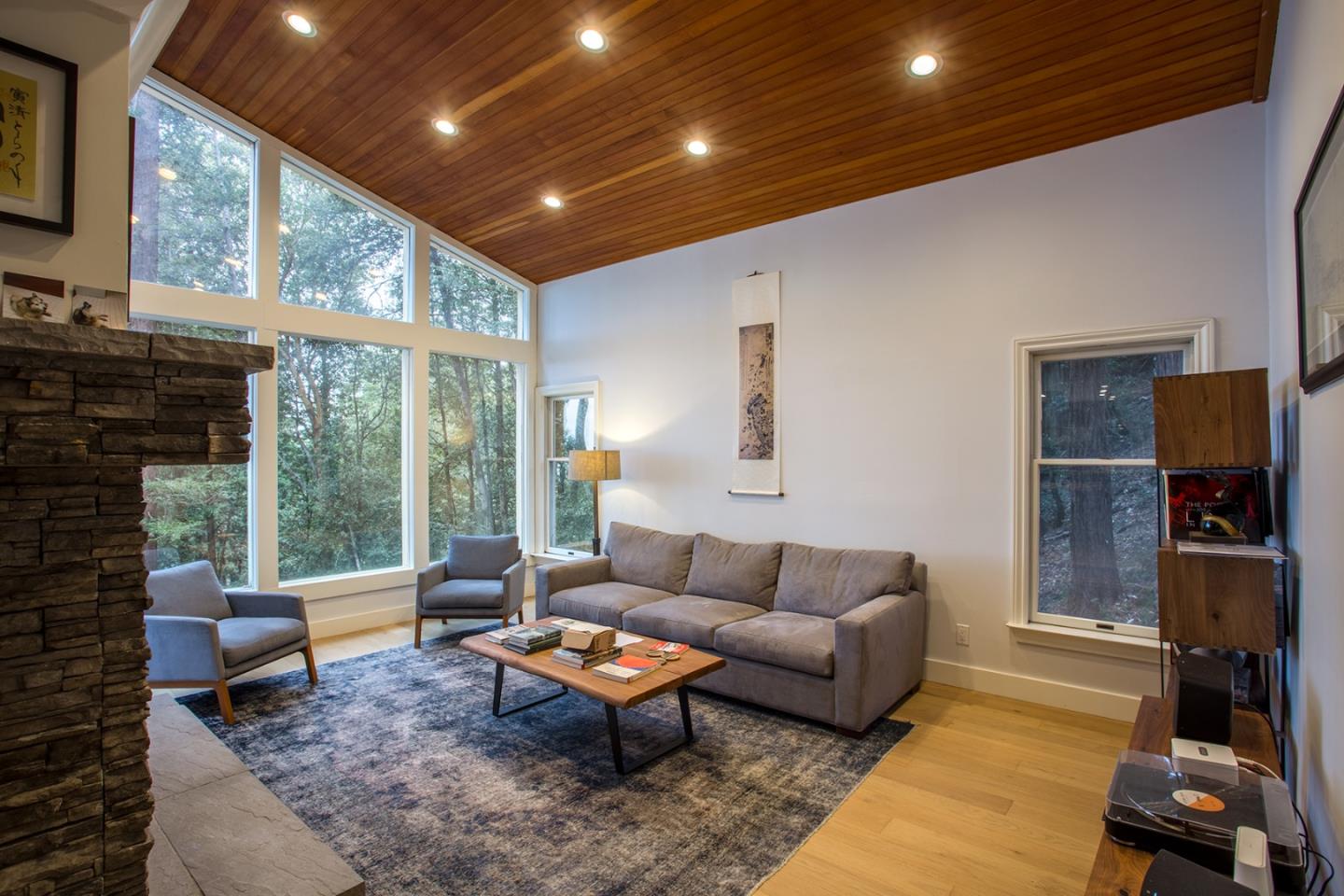 234 Swett Road Woodside, CA 94062 - Photo 2 of 20 a living room with furniture a flat screen tv and a floor to ceiling window