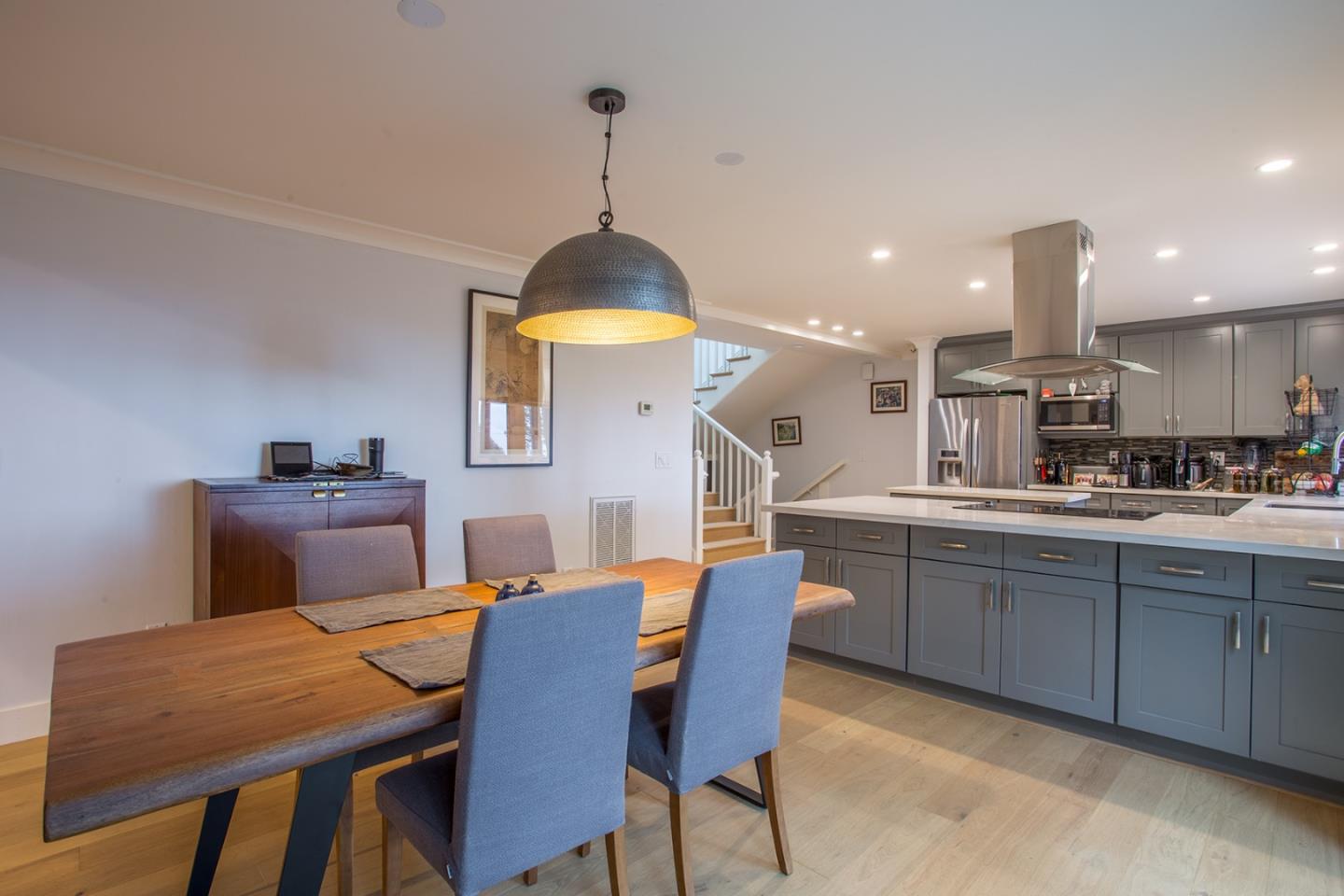234 Swett Road Woodside, CA 94062 - Photo 8 of 20 a kitchen with stainless steel appliances granite countertop a sink a stove a dining table and chairs with wooden floor