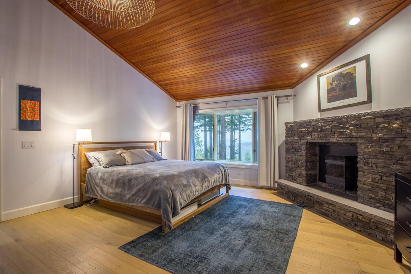 234 Swett Road Woodside, CA 94062 - Photo 9 of 20 a bedroom with a bed and a fireplace