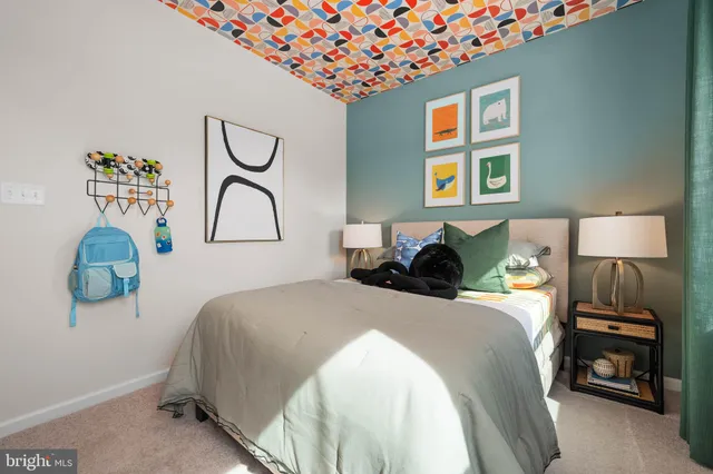 a bedroom with bed and a large mirror