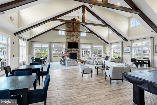 a open kitchen with stainless steel appliances granite countertop a kitchen island a stove and a wooden cabinets