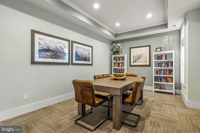 a large kitchen with stainless steel appliances a stove a chimney a dining table and chairs