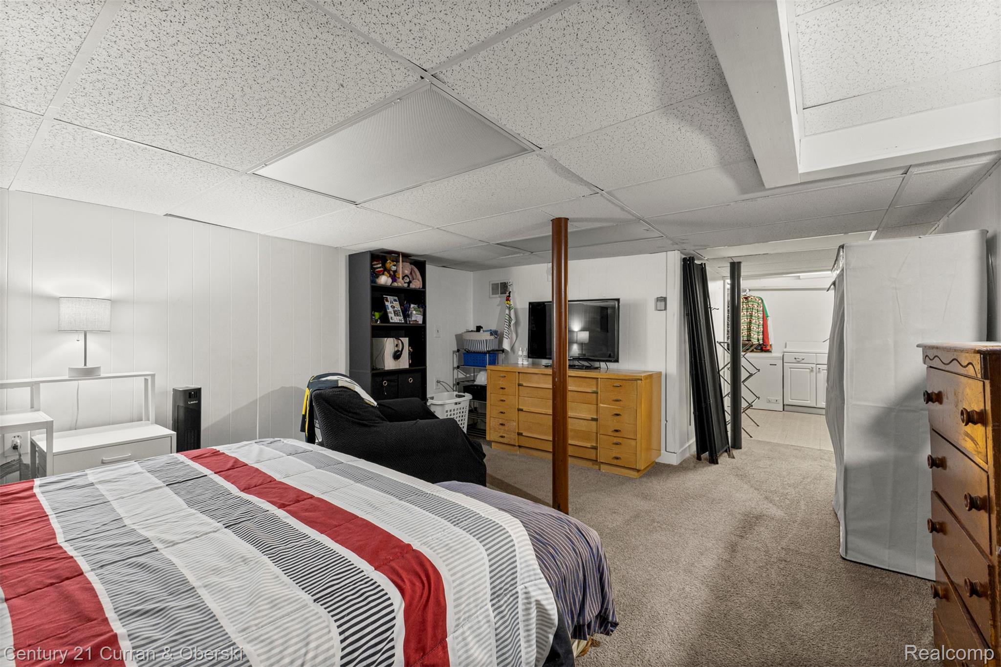 31083 Hoover Road, Unit 12 Warren, MI 48093 - Photo 29 of 39 Finished space featuring drop ceiling, carpet flooring, paneled walls, and a visible laundry area with built-in washer and dryer units