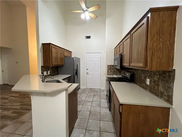 a kitchen with stainless steel appliances a refrigerator and a sink