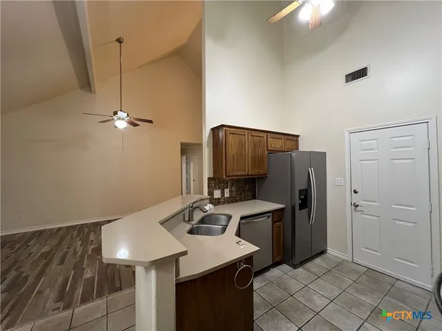 a kitchen with a refrigerator sink and stove