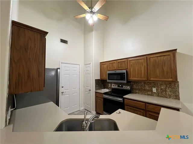 a kitchen with a sink and cabinets