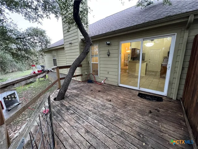 a backyard of a house with barbeque oven and outdoor seating