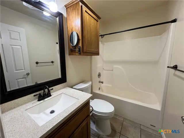 an empty room with closet and fan