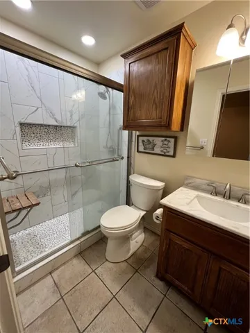 an empty room with closet and a chandelier fan