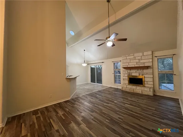 wooden floor in an empty room with a fireplace