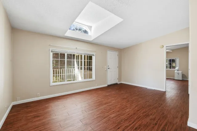 wooden floor in an empty room with a window