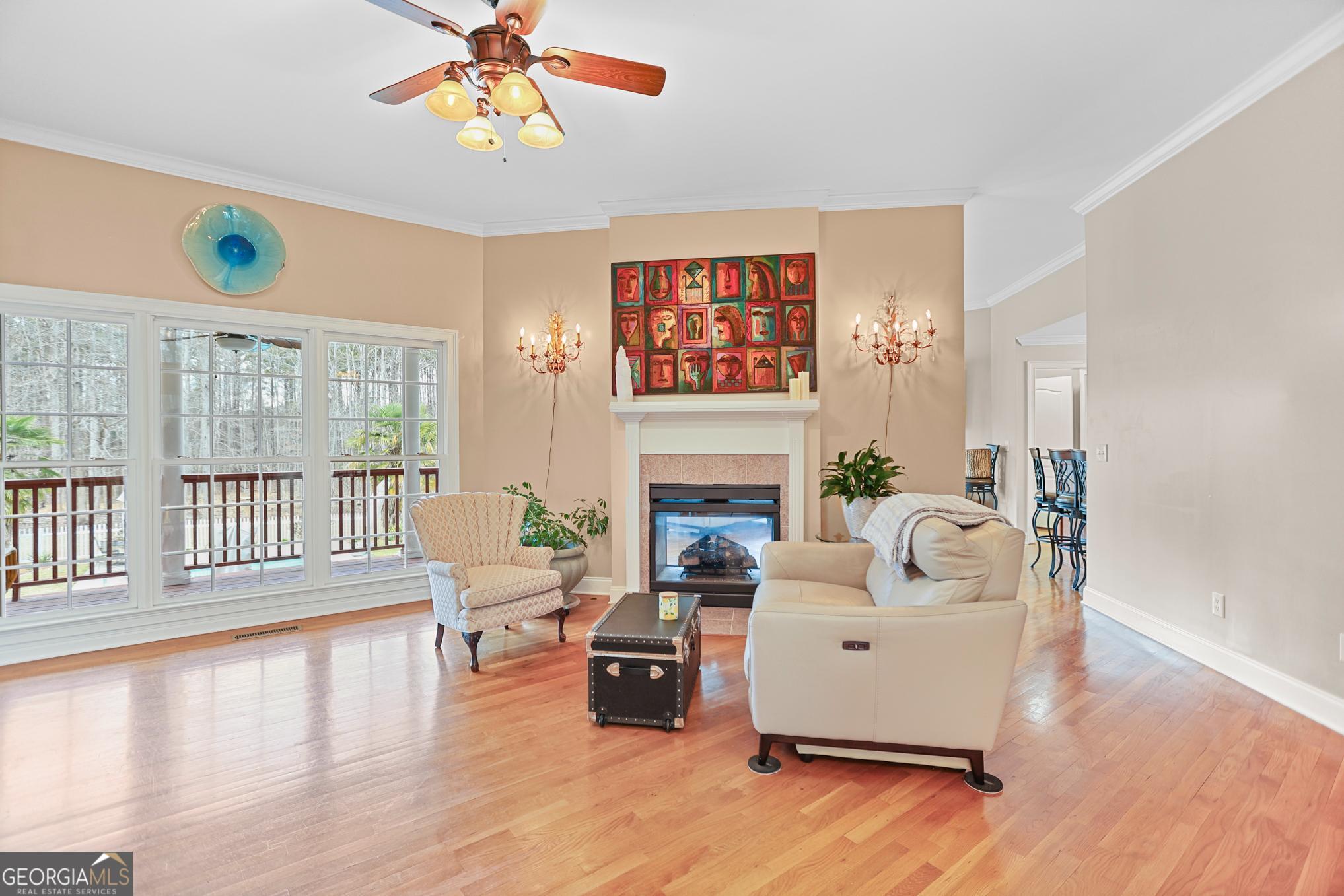 643 Old Greenville Road Fayetteville, GA 30215 - Photo 11 of 59 a living room with furniture a fireplace and a dining table with wooden floor
