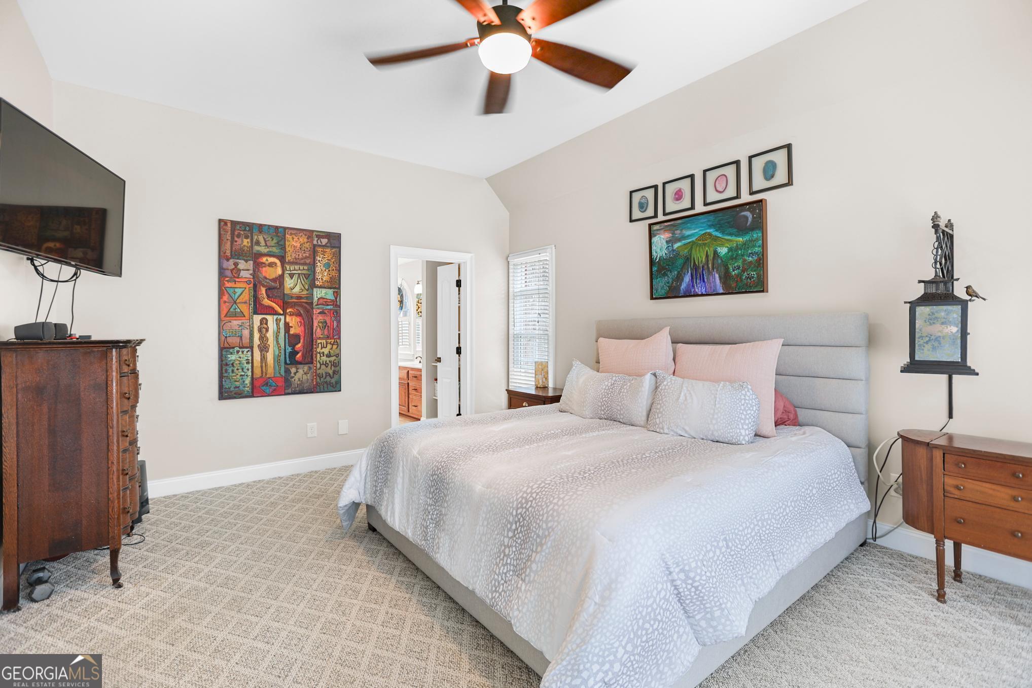 643 Old Greenville Road Fayetteville, GA 30215 - Photo 16 of 59 a bedroom with a bed and a flat screen tv