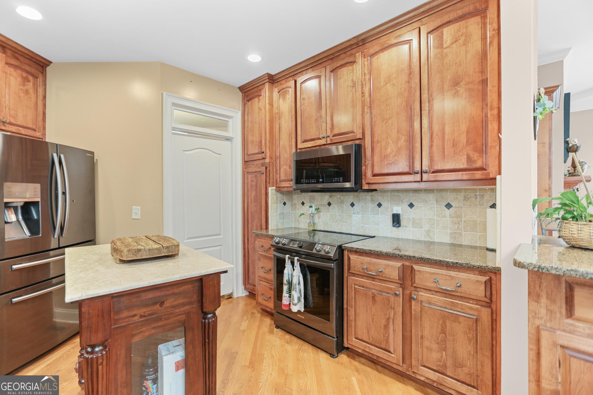 643 Old Greenville Road Fayetteville, GA 30215 - Photo 25 of 59 a kitchen with stainless steel appliances granite countertop a stove a sink and a microwave