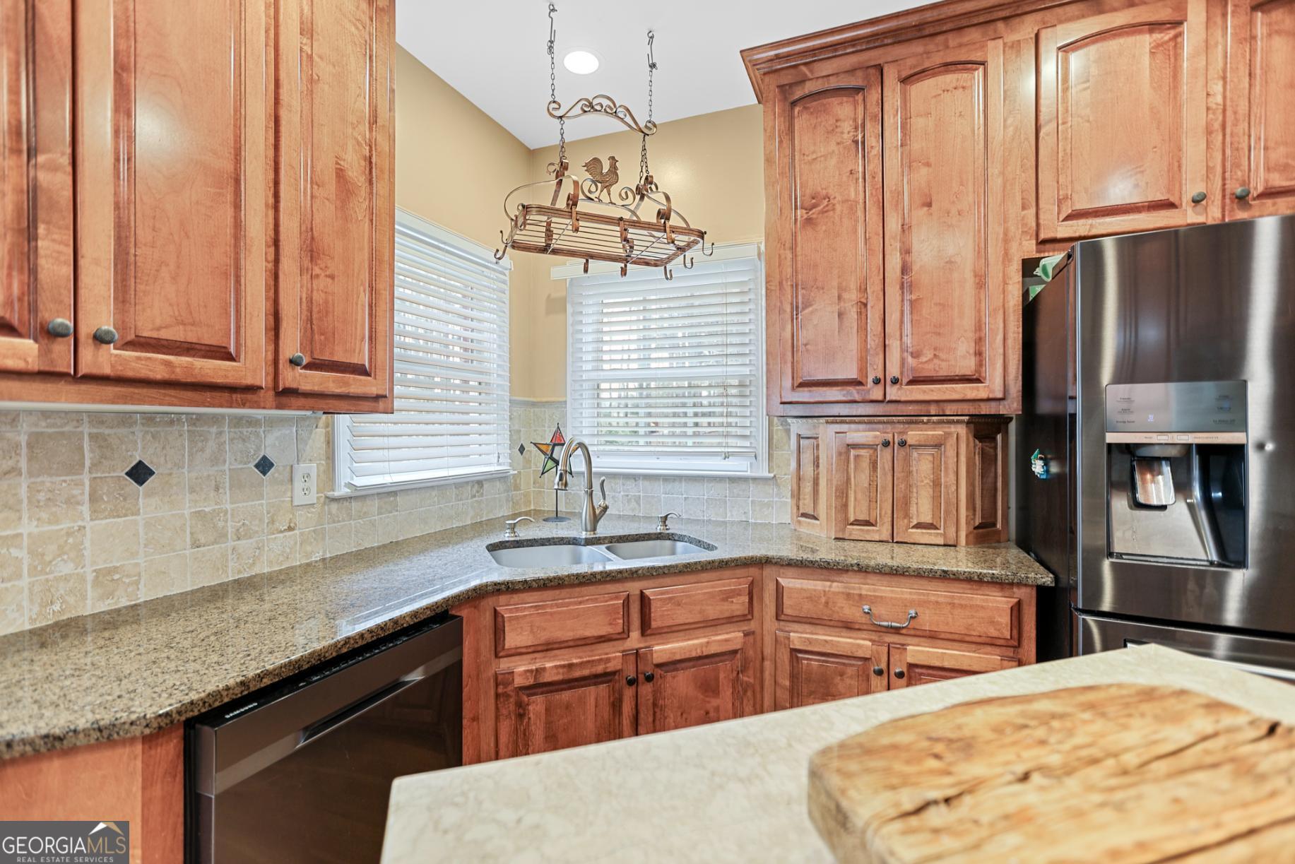643 Old Greenville Road Fayetteville, GA 30215 - Photo 27 of 59 a kitchen with stainless steel appliances granite countertop a sink a stove and refrigerator