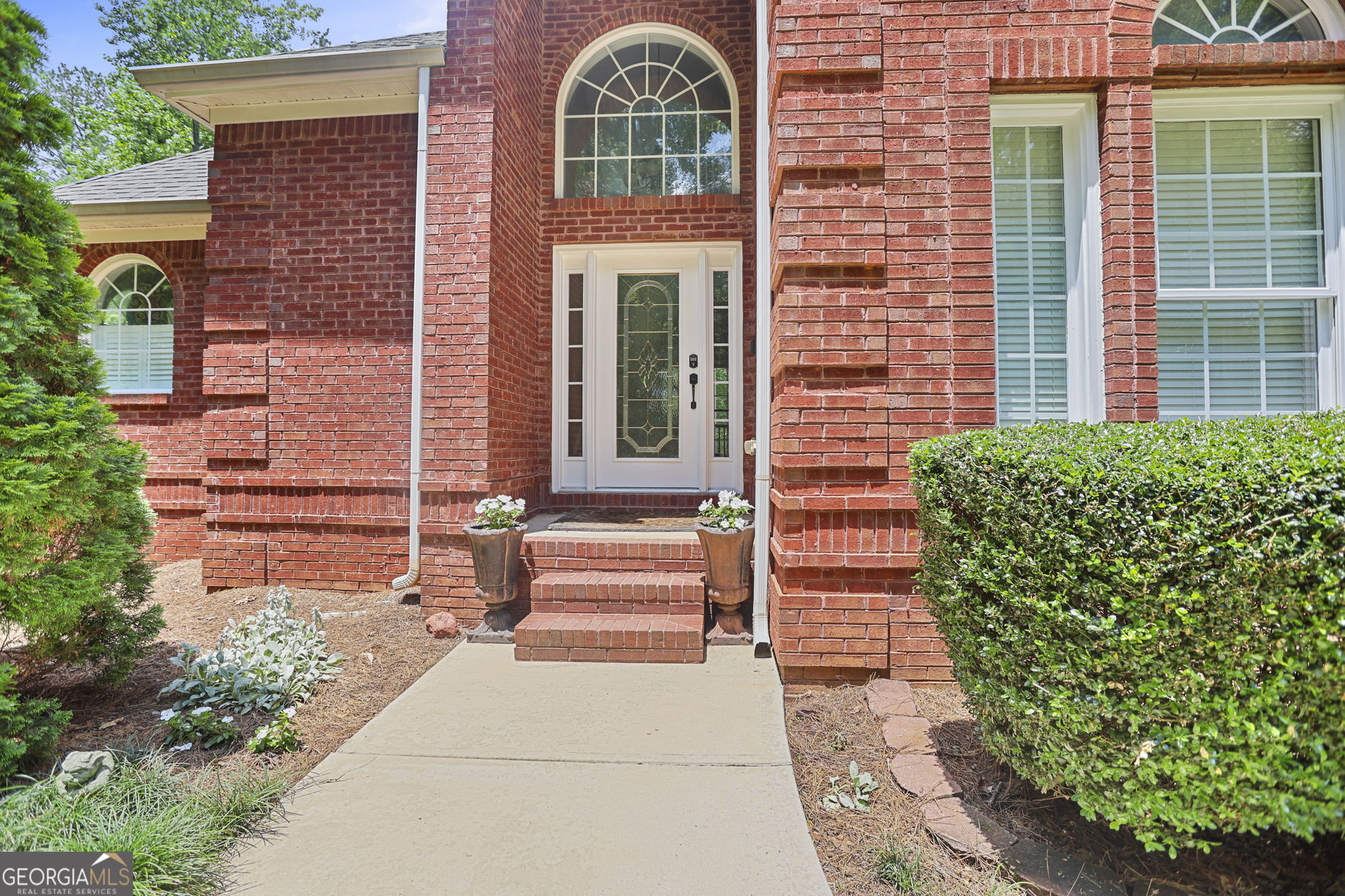 643 Old Greenville Road Fayetteville, GA 30215 - Photo 3 of 59 a front view of a house with a garden
