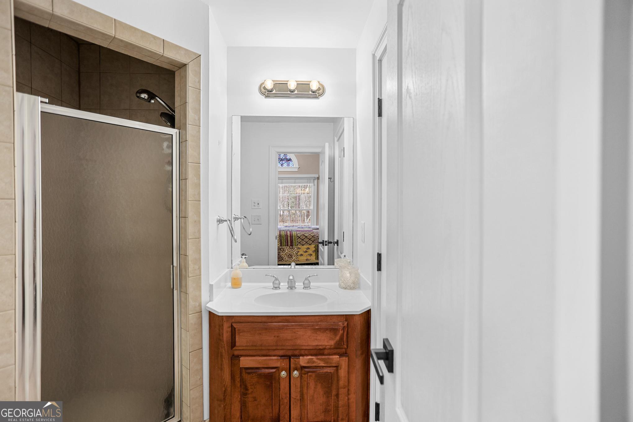 643 Old Greenville Road Fayetteville, GA 30215 - Photo 36 of 59 a bathroom with a sink and a mirror
