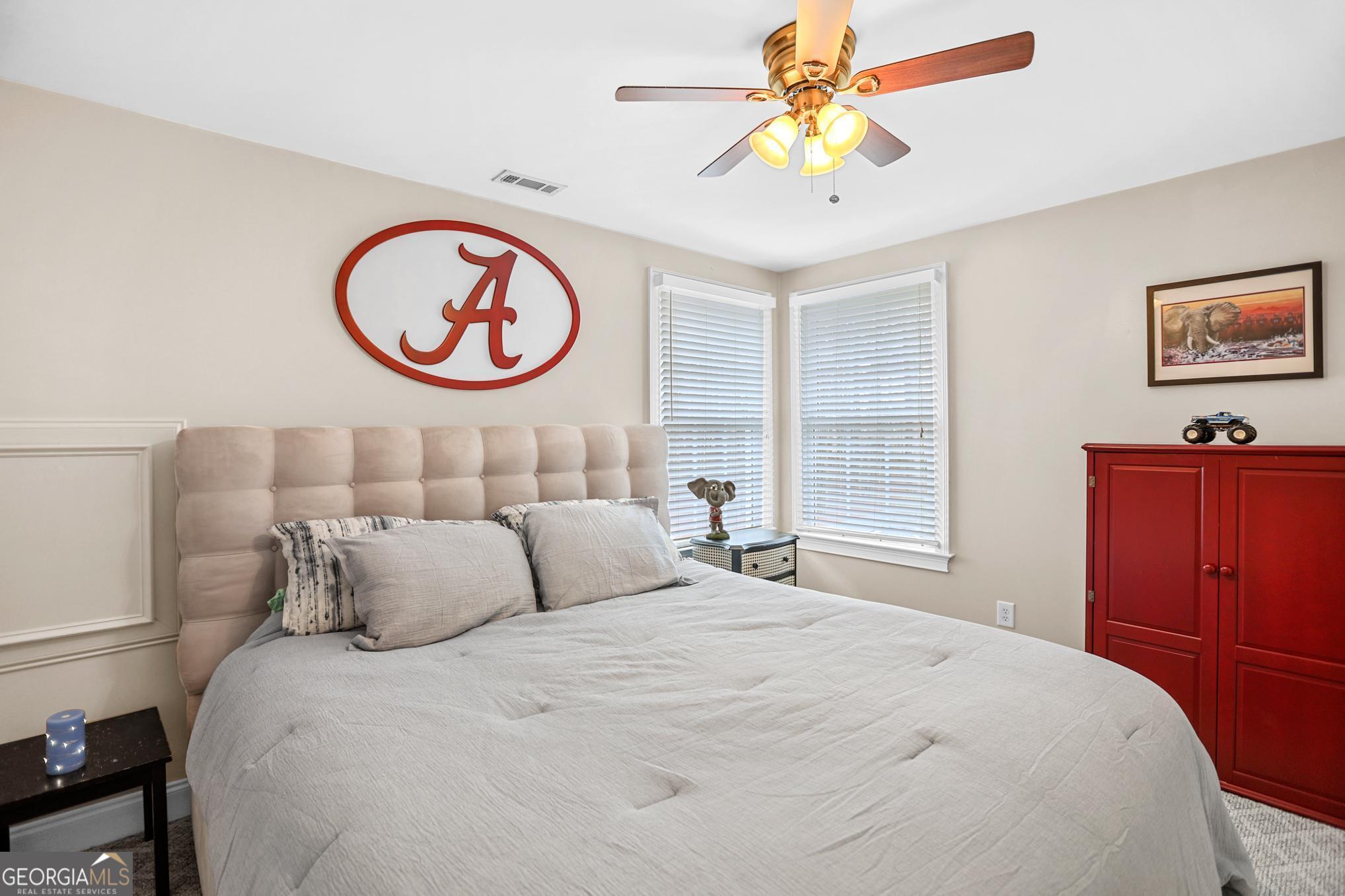 643 Old Greenville Road Fayetteville, GA 30215 - Photo 37 of 59 a bedroom with a bed and a chandelier