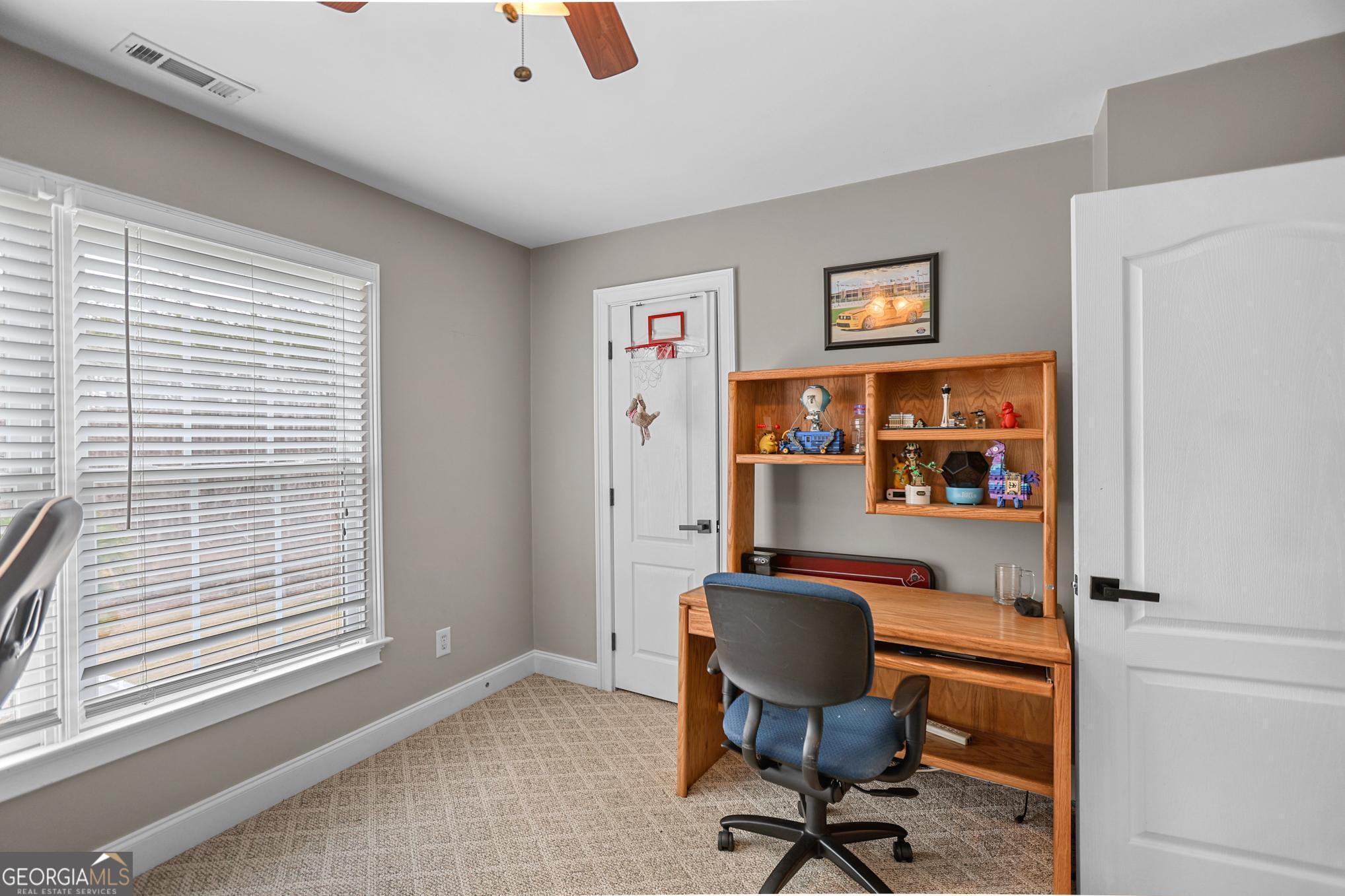 643 Old Greenville Road Fayetteville, GA 30215 - Photo 39 of 59 a view of a workspace with furniture and a window