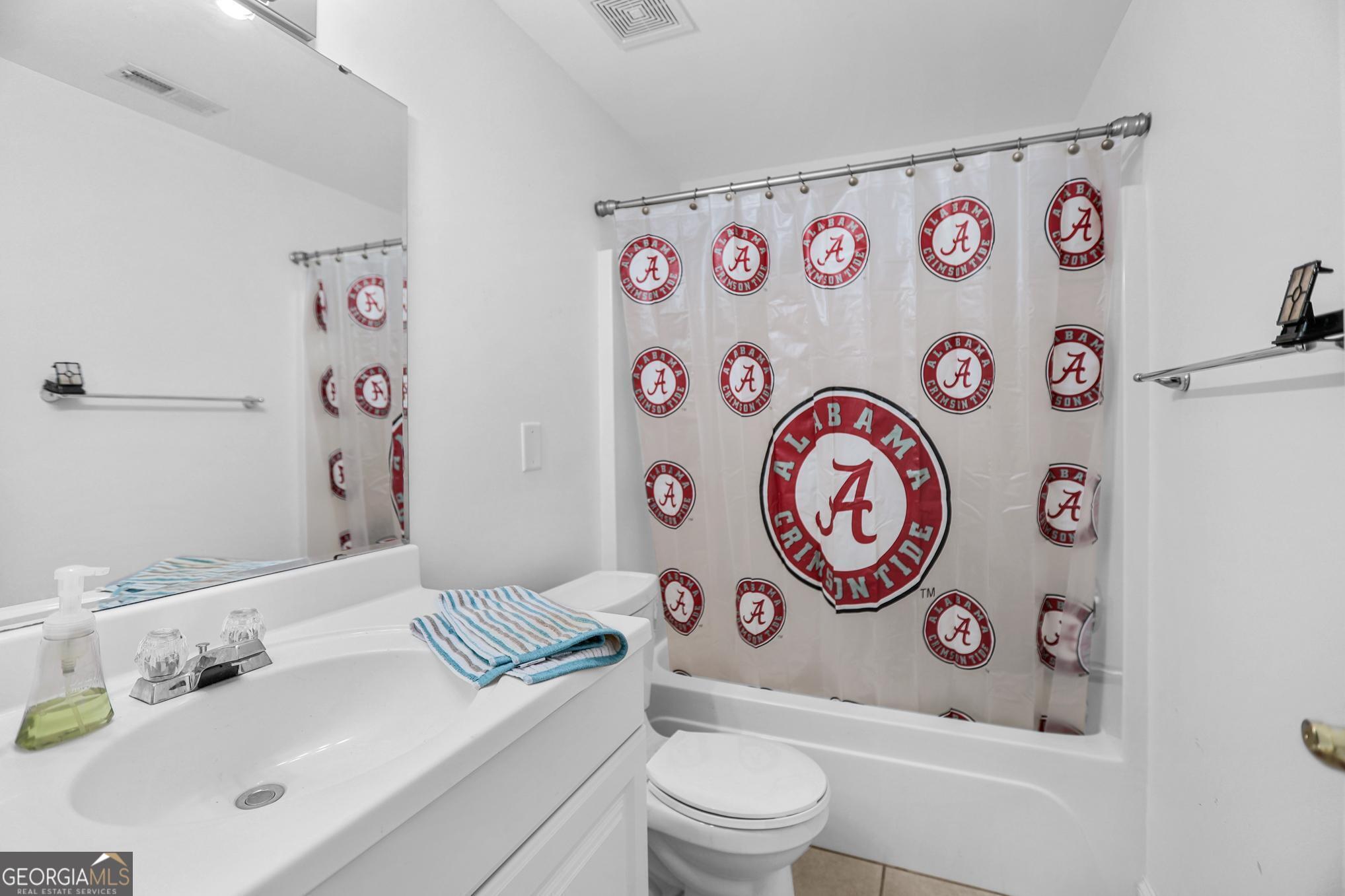 643 Old Greenville Road Fayetteville, GA 30215 - Photo 47 of 59 a bathroom with a sink a toilet and a shower curtain