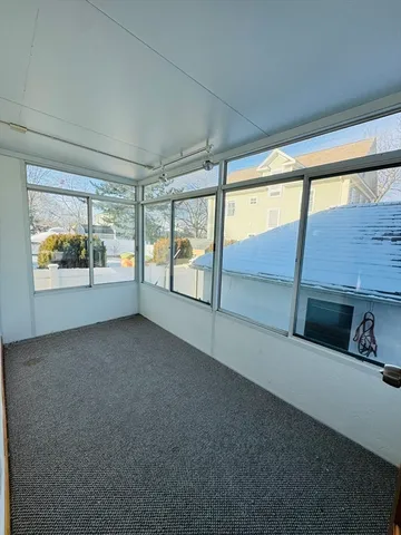 a backyard of a house with table and chairs