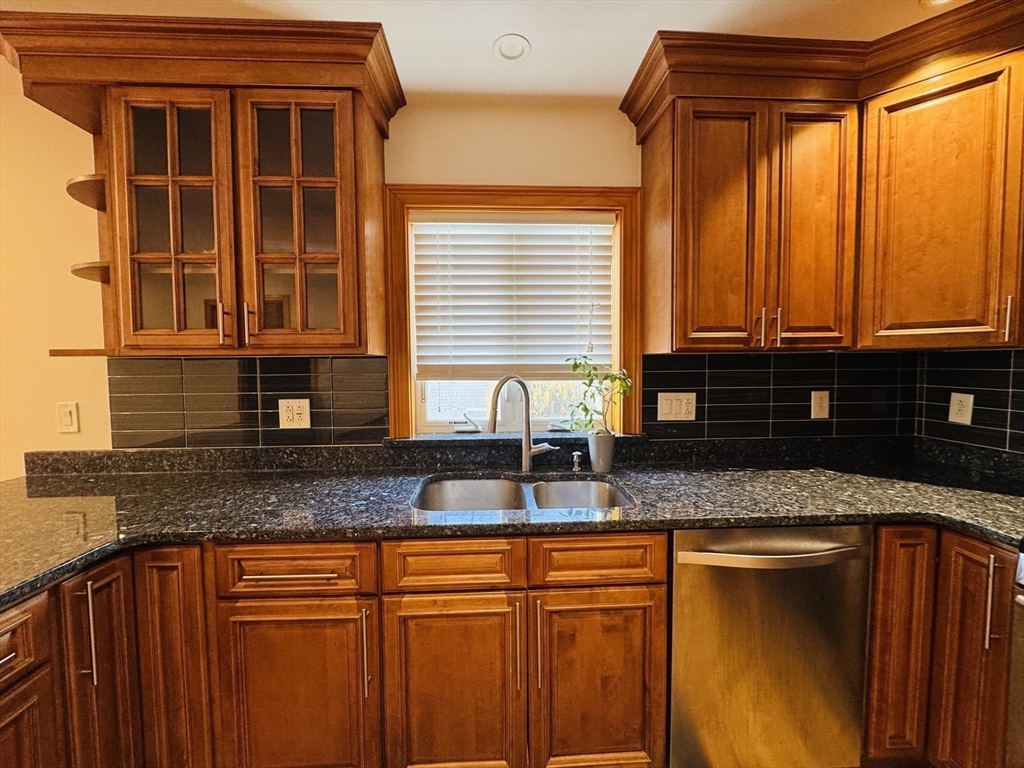 162 Palmer Street Quincy, MA 02169 - Photo 5 of 21 a kitchen with granite countertop a sink and cabinets