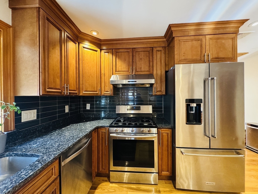 162 Palmer Street Quincy, MA 02169 - Photo 6 of 21 a kitchen with granite countertop a refrigerator and a sink