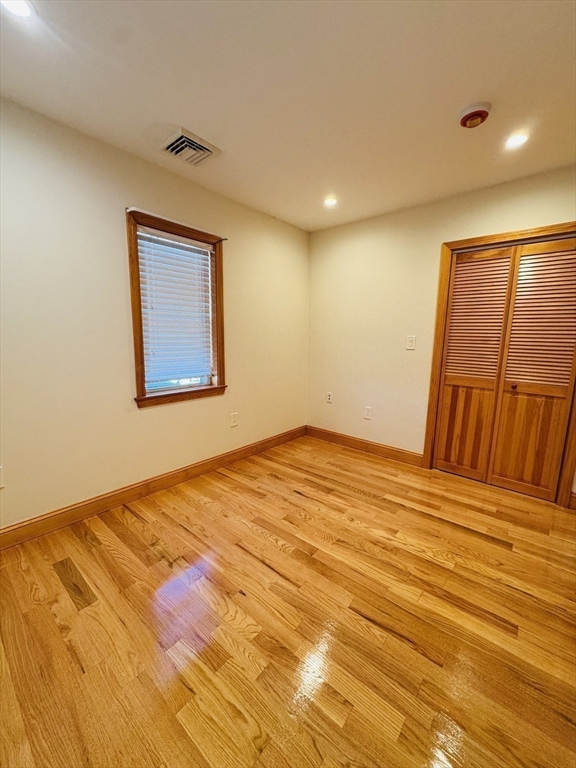 162 Palmer Street Quincy, MA 02169 - Photo 8 of 21 a bedroom with a bed and a painting on the wall